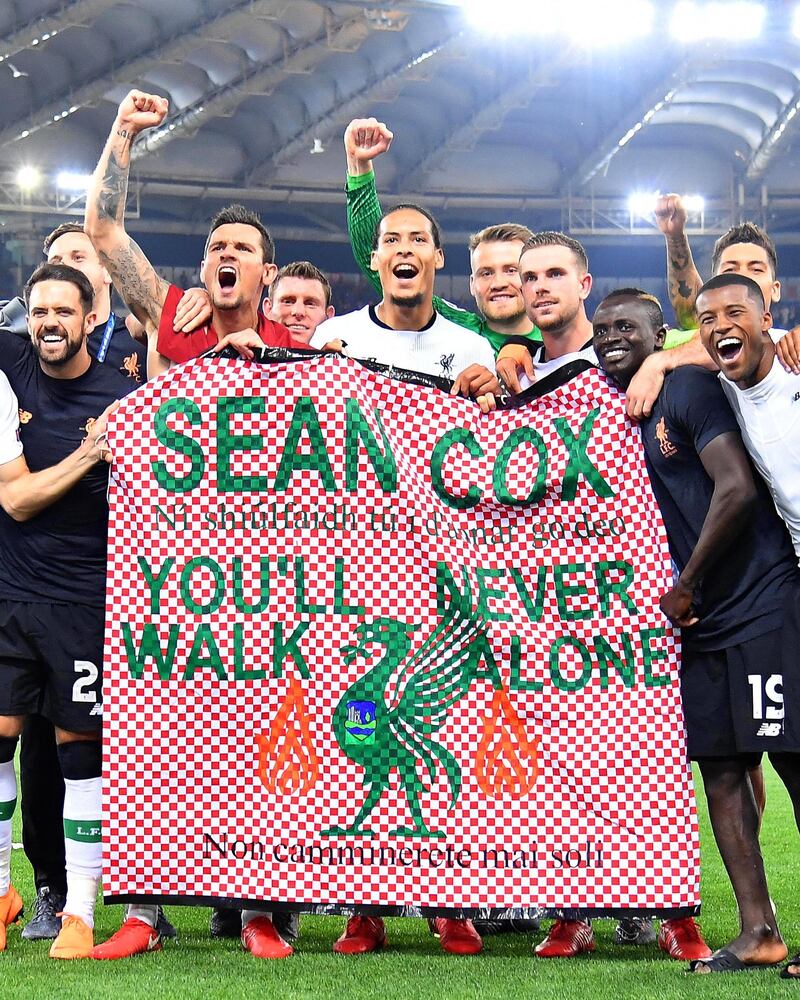 Liverpool players celebrate with a banner supporting Liverpool fan Sean Cox who was severly injured during clashes ahead of the first-leg match at Anfield last month. Liverpool won 7-6 on aggregate.  Ettore Ferrari / EPA/