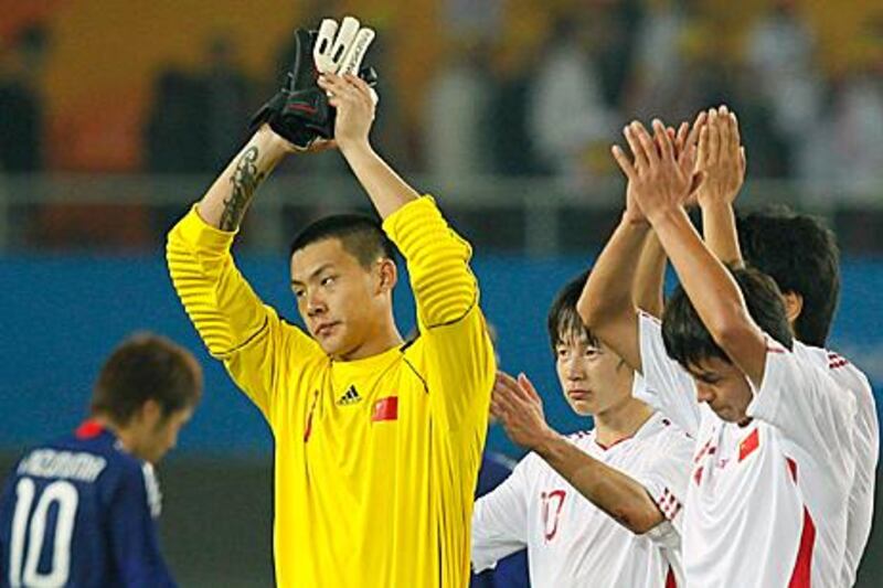 Wang Dalei gestures to the crowd after China’s loss to Japan in their opening match as the Asian Games.