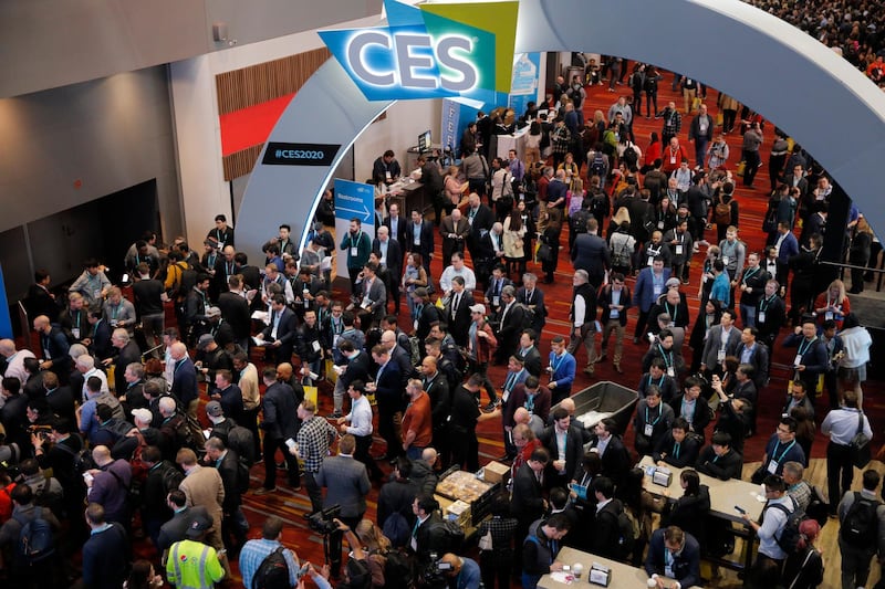 FILE - In this Jan. 7, 2020 file photo, crowds enter the convention center on the first day of the CES tech show,  in Las Vegas. Every January, huge crowds descend on Las Vegas for the CES gadget show, an extravaganza of tech and glitz intended to set the tone for the coming year in consumer technology. CES kicks off this week, but thanks to the pandemic, it will be in a radical new format â€” a â€œvirtualâ€ show taking place only in cyberspace. (AP Photo/John Locher, File)