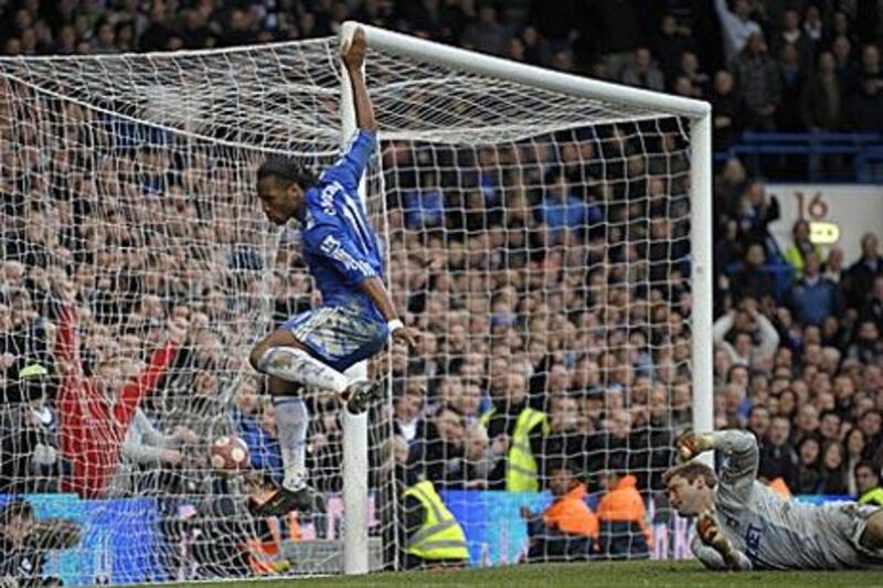 Didier Drogba, left, scores Chelsea's fourth with Robert Green, the West Ham keeper, stranded.