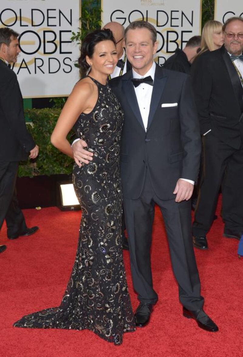 Luciana Barroso, left, and Matt Damon arrive at the 71st annual Golden Globe Awards. AP