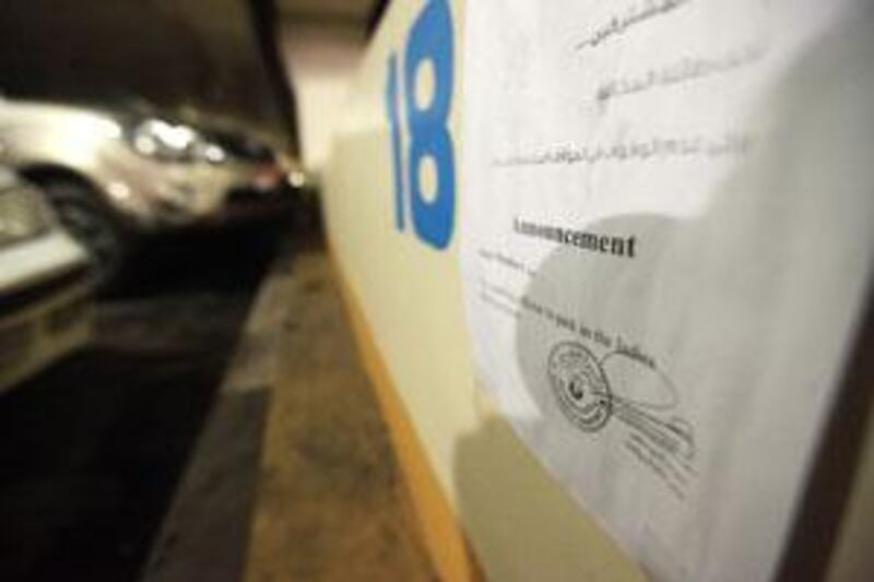 A memo is posted to the first row of parking spaces on Hamdan Street in Abu Dhabi.