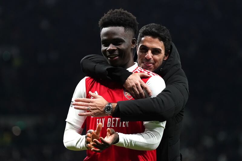 Arsenal's Bukayo Saka celebrates with manager Mikel Arteta. PA