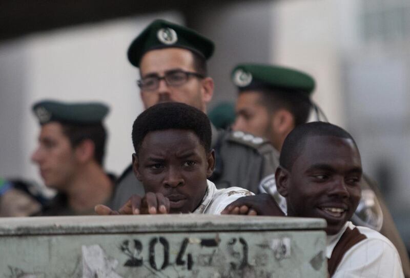 African migrants stand in front of Israeli border police in Tel Aviv. Ariel Schalit / AP Photo