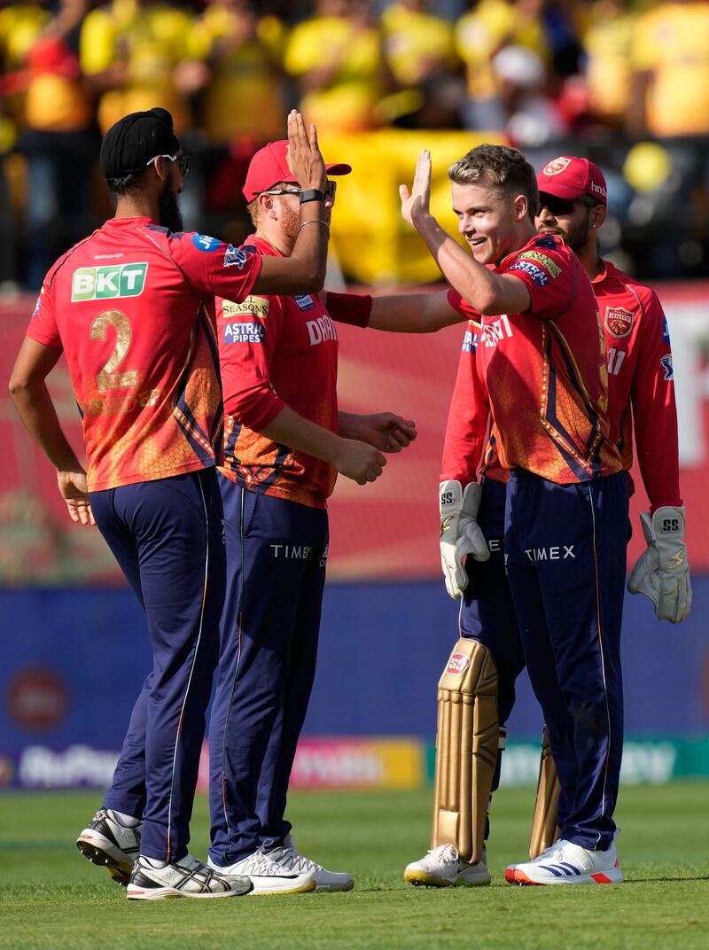 Punjab Kings captain Sam Curran, second right, celebrates with teammates the wicket of Chennai Super Kings' Moeen Ali, who made 17. AP 