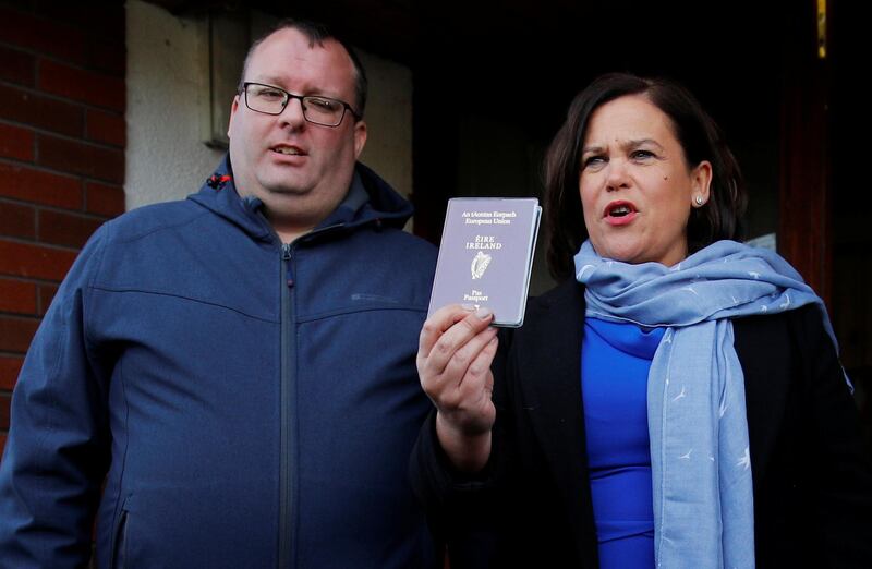 Sinn Fein leader Mary Lou McDonald shows her passport as she leaves the polling station after casting her vote in Ireland's national election, in Dublin, Ireland. REUTERS