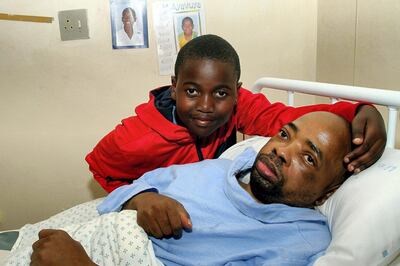 EAST LONDON, SOUTH AFRICA  SEPTEMBER 10: (SOUTH AFRICA OUT):  Ayanda Nqinana reunites with his son Ayavuya on September 10, 2012 after waking from a seven-year coma in East London, South Africa. (Photo by Yandisa Monakali/Daily Dispatch/Gallo Images/Getty Images)