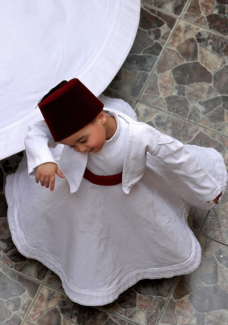 Anas Al Kharrat, 3, dances at his home. AFP