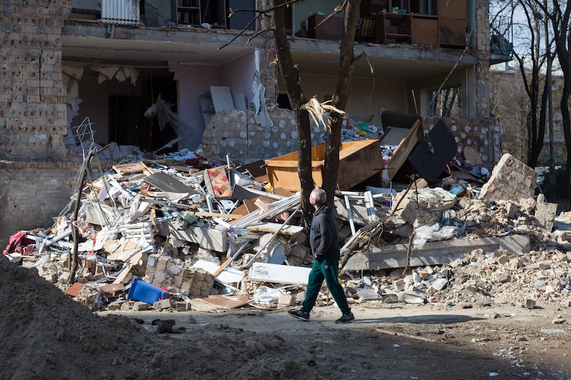 A man walks past a residential area destroyed by a rocket strike in Kyiv.  Getty Images