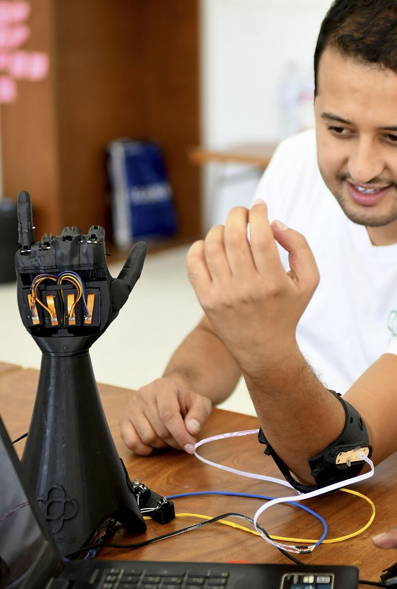 Tunisian engineer Mohamed Dhaouafi tests a prototype of an artificial hand at Cure Bionics startup in Sousse. AFP