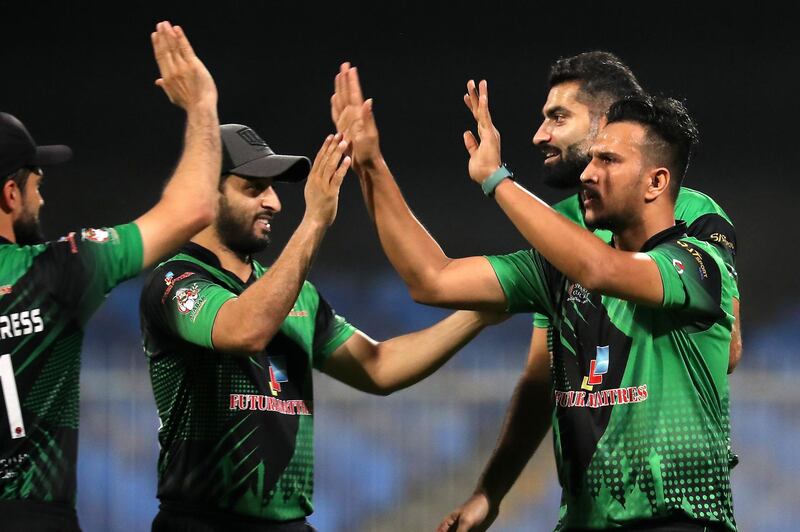 Umair Ali (RIGHT) of Future Mattress celebrating after taking the wicket in the Sharjah Ramadan Cup final between Future Mattress vs MCM Cricket Club held at Sharjah International Cricket Stadium in Sharjah on May 7,2021. Pawan Singh / The National. Story by Paul