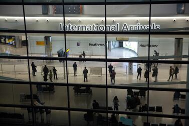People in the arrivals area at Heathrow Airport in London. AP