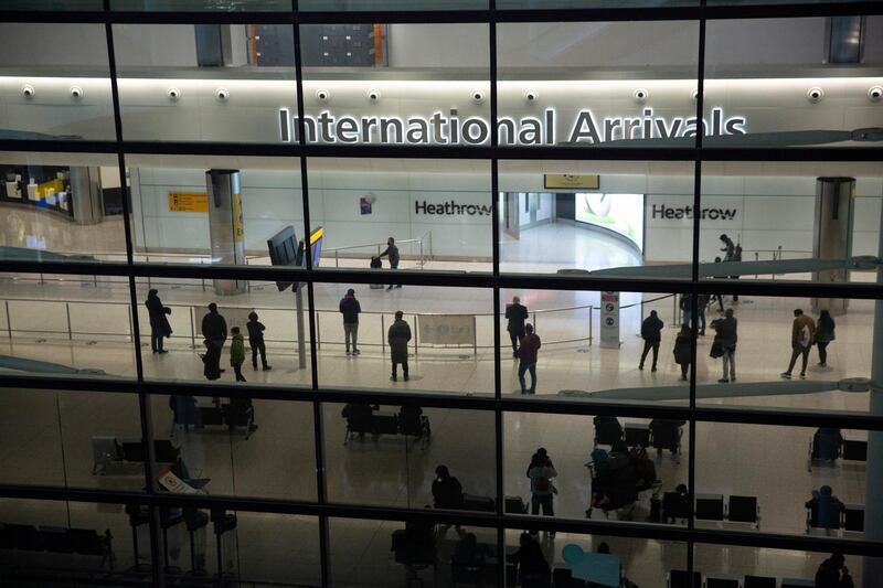 People in the arrivals area at Heathrow Airport in London, Tuesday, Jan. 26, 2021, during England's third national lockdown since the coronavirus outbreak began. The British government are on Tuesday expected to discuss whether to force some travellers arriving in the UK to quarantine in hotels to try to curb the spread of coronavirus. (AP Photo/Matt Dunham)