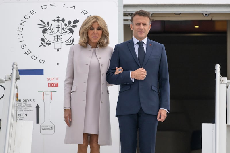 French President Emmanuel Macron and his wife Brigitte Macron arrive at the military section of BER Airport, in France, ahead of their three-day state visit to Germany, Sunday, May 26, 2024.  (Christophe Gateau / dpa via AP)