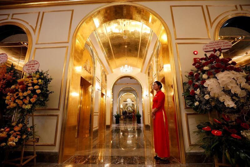 An employee in traditional dress is seen in the newly inaugurated Dolce Hanoi Golden Lake luxury hotel, which features gold-plated exteriors and interiors, in Hanoi, Vietnam. Reuters