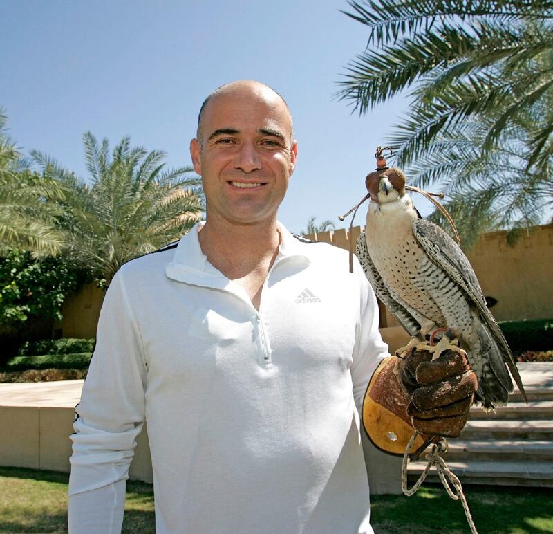 RESIZED. American tennis players Andre Agassi poses for a picture with three-year-old female Peregrine falcon named DJ in Dubai 27 February 2006. Agassi will take part in the Dubai Open which will start today.     AFP PHOTO/JORGE FERRARI / AFP PHOTO / JORGE FERRARI