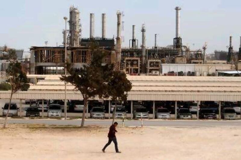 A man walks past the Azzawiya oil refinery in Zawiyah, 50km west of Tripoli. Reuters