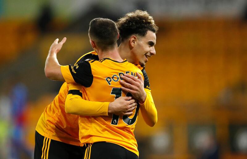 WOLVERHAMPTON, ENGLAND - OCTOBER 30: Daniel Podence of Wolverhampton Wanderers celebrates with teammate Rayan Ait-Nouri after scoring his team's second goal during the Premier League match between Wolverhampton Wanderers and Crystal Palace at Molineux on October 30, 2020 in Wolverhampton, England. Sporting stadiums around the UK remain under strict restrictions due to the Coronavirus Pandemic as Government social distancing laws prohibit fans inside venues resulting in games being played behind closed doors. (Photo by Andrew Boyers - Pool/Getty Images)