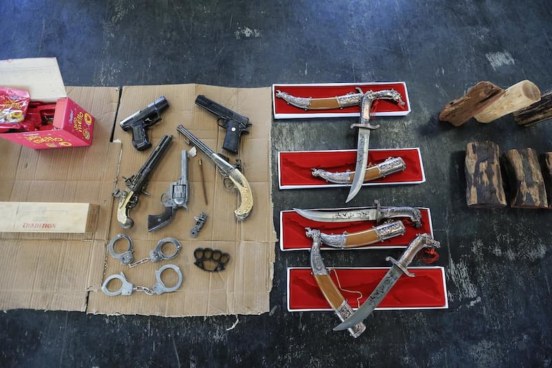 Counterfeit cigarettes and weapons seized by Dubai Customs in Jebel Ali Port in Dubai. Sarah Dea / The National