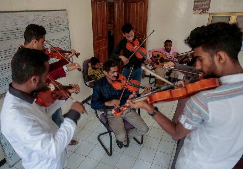 Abdullah El-Deb'y, center, teaches his students during a music class at the Cultural Centre in Sanaa, Yemen.  Hani Mohammed / AP Photo