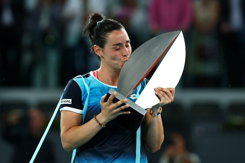 Ons Jabeur celebrates with the Madrid Open trophy following victory in the final against Jessica Pegula. Getty