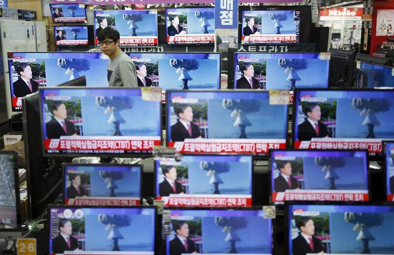 A sales assistant in Seoul, South Korea watches TV sets broadcasting a news report on North Korea’s hydrogen bomb test. Kim Hong-ji / Reuters