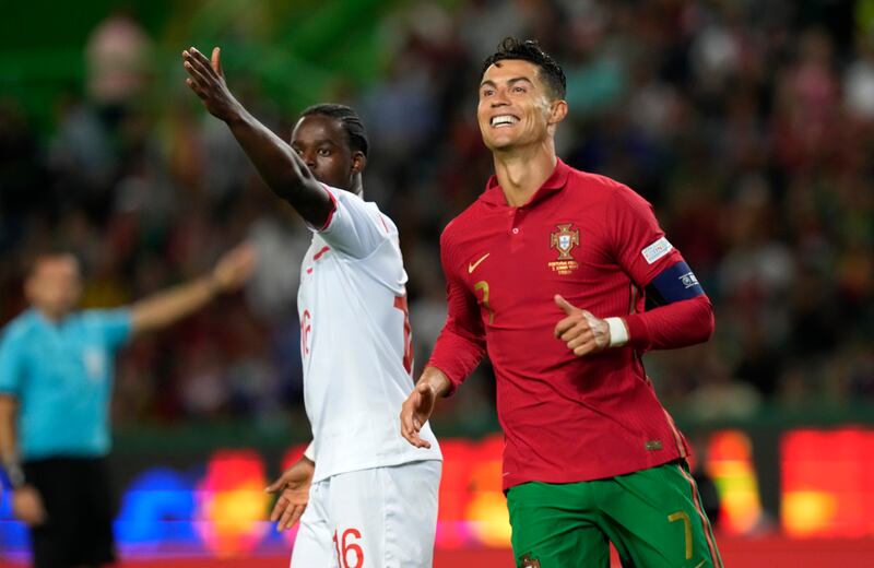 Portugal's Cristiano Ronaldo, right, and Switzerland's Jordan Lotomba react during the UEFA Nations League soccer match between Portugal and Switzerland, at the Jose Alvalade Stadium in Lisbon, Portugal, Sunday, June 5, 2022.  (AP Photo / Armando Franca)