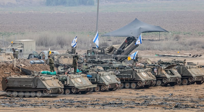 Israeli soldiers and military vehicles near the border with Gaza. EPA