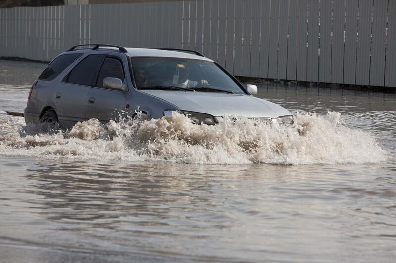 DUBAI, UNITED ARAB EMIRATES, NOVEMBER 22, 2013. Motorists and pedestrians deal with the heavey flooding in Sharjah's Industrial Area One just behind Sharjah City Center. (Photo: Antonie Robertson/The National) Journalist None. Section: National