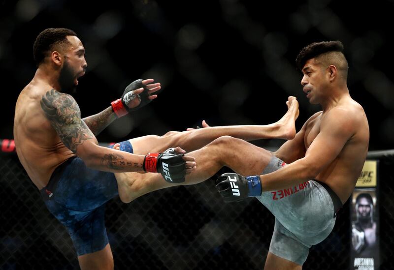 Andre Ewell, left, and Jonathan Martinez during their bantamweight clash at UFC 247. AFP