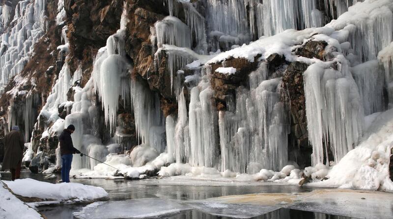 A Kashmiri man fishes near a frozen waterfall in the Drang area of Tangmarg, north of Srinagar, the summer capital of Indian Kashmir. EPA