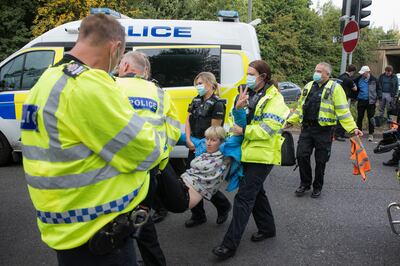 Police officers arrest an Insulate Britain activist. Getty 