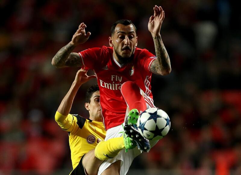 Kostas Mitroglou of Benfica battles for the ball with Marc Bartra of Dortmund. Lars Baron / Getty Images