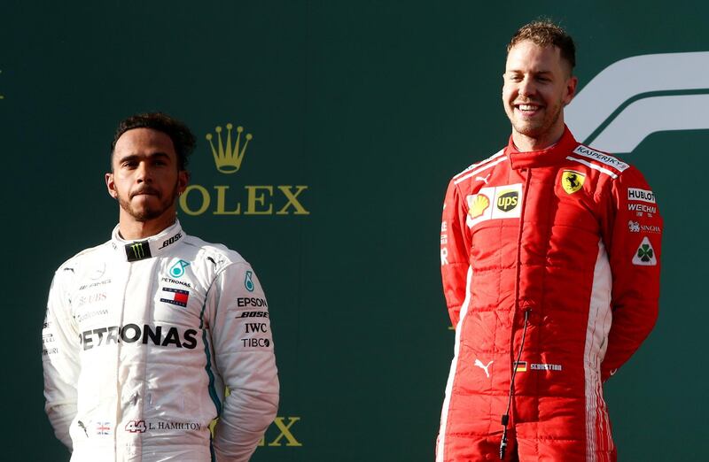 Formula One F1 - Australian Grand Prix - Melbourne Grand Prix Circuit, Melbourne, Australia - March 25, 2018  Ferrari's Sebastian Vettel celebrates his win on the podium with Mercedes' Lewis Hamilton  REUTERS/Brandon Malone