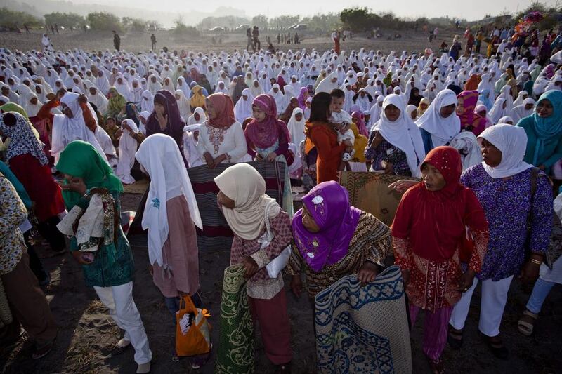 Muslims attend Eid Al Adha prayers at Parangkusumo beach, Indonesia.