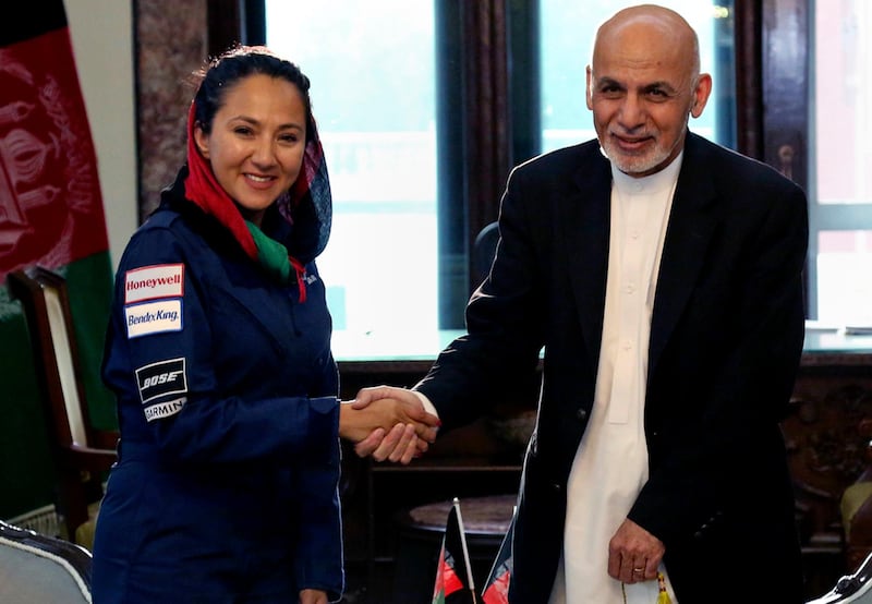 Afghan president Ashraf Ghani shaking hands with Afghan-American female pilot Shaesta Waiz at the presidential palace in Kabul, Afghanistan on July 10, 2017. Ms Waiz, who is on a solo flight around the world to inspire young women, has taken a detour to visit Afghanistan. Afghan Presidential Palace via AP