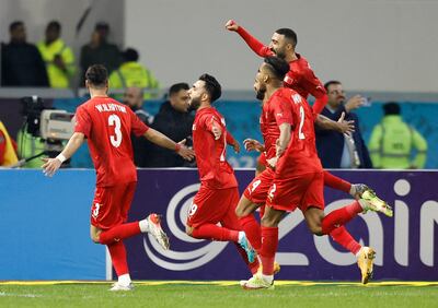 Bahrain's Kamil Al Aswad celebrates scoring their first goal with teammates. Reuters