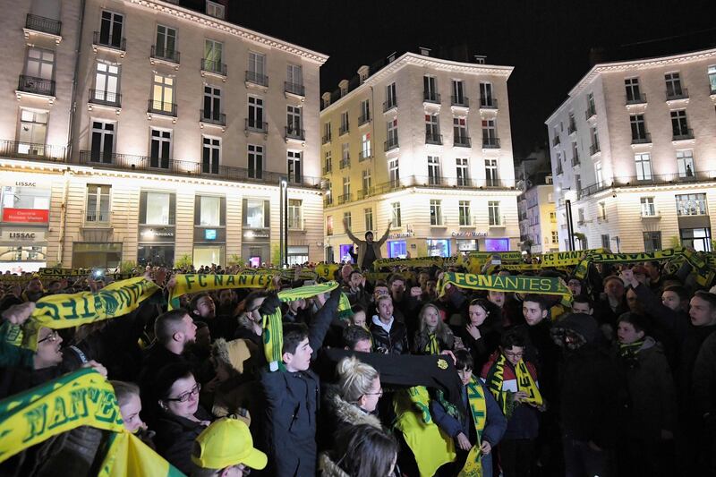 Nantes fans hold up club scarves during a gathering. AFP