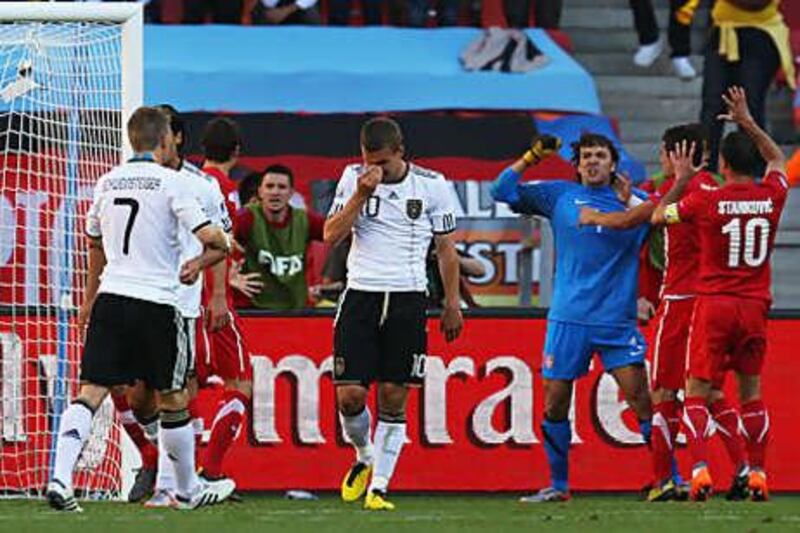 Serb goalkeeper Vladimir Stojkovic celebrates with teammates after he saved a penalty from Lukas Podolski, centre. It was the first penalty missed by the Germans in a World Cup for 28 years.