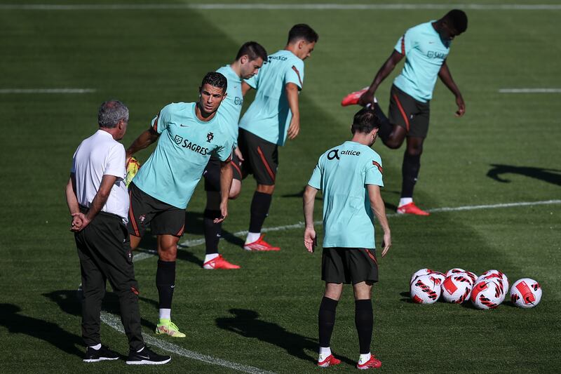 Cristiano Ronaldo talks to Portugal manager Fernando Santos during training on Monday, August 30. EPA