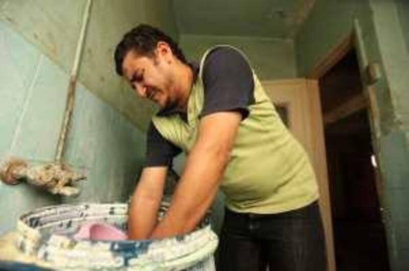 Hassan Sabit Mohammed, 24, works in making industrial soap. He works a total of 4 jobs, working about 87 hours a week,  and taking home only LE 1050 a month, in order to support his mother, sister, wife and child. September 6, 2009. Victoria Hazou *** Local Caption ***  VH_workers.005.JPG