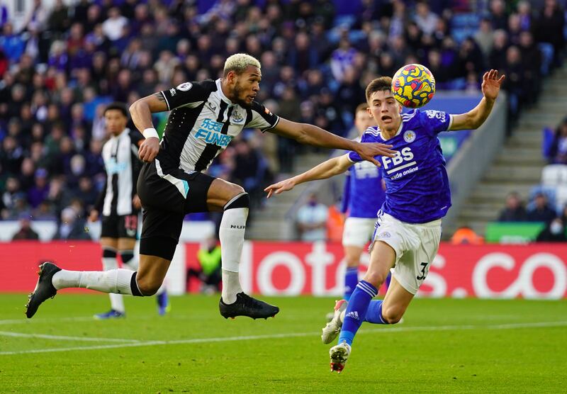 Newcastle striker Joelinton and Leicester City's Luke Thomas battle for the ball. PA