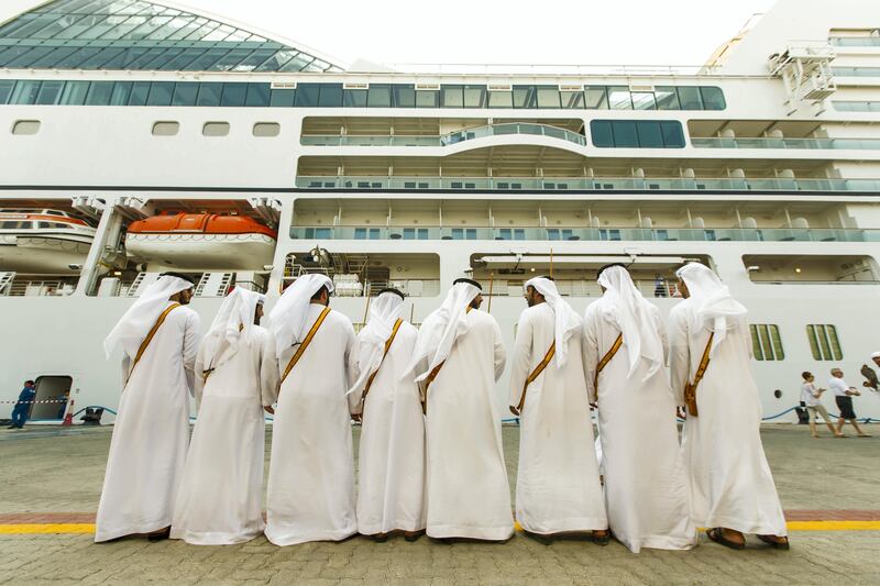 Abu Dhabi, United Arab Emirates, October 23, 2017:    Emirati men dance while passengers disembark from the Seabourn Encore ship at the cruise terminal in the Mina Zayed area of Abu Dhabi on October 23, 2017. Christopher Pike / The National

Reporter: John Dennehy
Section: News