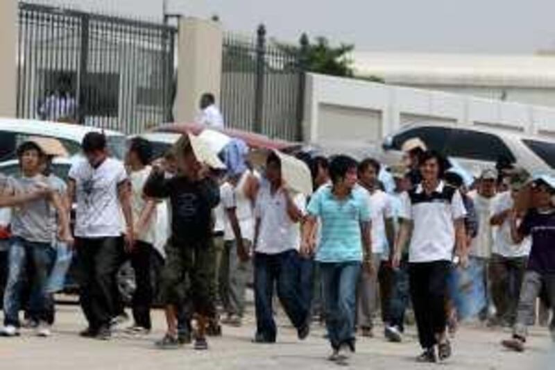 DUBAI, UNITED ARAB EMIRATES, May 4: Asian workers gathered outside the office of Ministry of Labour in Dubai. (Pawan Singh / The National) For News. Story by Praveen Menon
