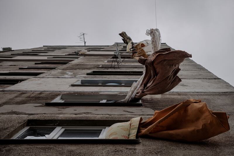 Curtains flutter in the wind at a building that was damaged by shelling in a neighbourhood that has been largely abandoned and left without water, gas and heating, as Russia's attack on Ukraine continues, in Kharkiv, Ukraine. Reuters