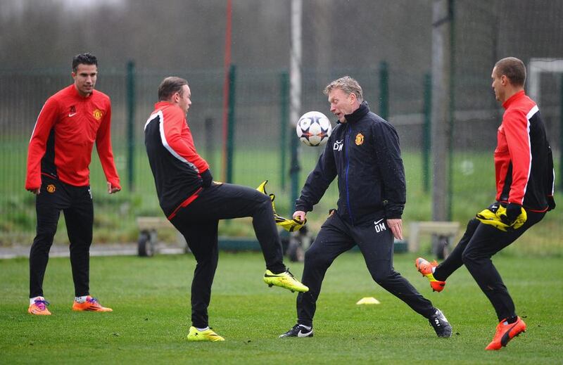 David Moyes of Manchester United challenges Wayne Rooney during the training session on Tuesday. Laurence Griffiths / Getty Images / March 18, 2014