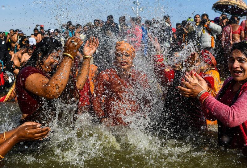 TOPSHOT - In this photograph taken on January 15, 2019, followers of the Kinnar Akhara monastic Hindu order made up of transgender members take a dip in the Sangam -- the confluence of the Ganges, Yamuna and mythical Saraswati rivers -- during the auspicious bathing day of Makar Sankranti at the Kumbh Mela in Allahabad. For decades Laxmi Narayan Tripathi has fought untiringly India's conservative laws and beliefs to put her transgender community on a par with the rest of society, and now she has notched up a new milestone. On January 15 she and dozens of other resplendent "Kinnars" splashed in the sacred waters of the Ganga and Yamuna rivers alongside top Hindu ascetics at the immense Kumbh Mela festival in northern India.
 - 
 / AFP / CHANDAN KHANNA
