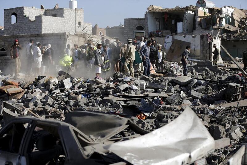 Civil defence workers and people search for survivors under the rubble of houses destroyed by an air strike near Sanaa Airport on March 26, 2015. Khaled Abdullah/Reuters