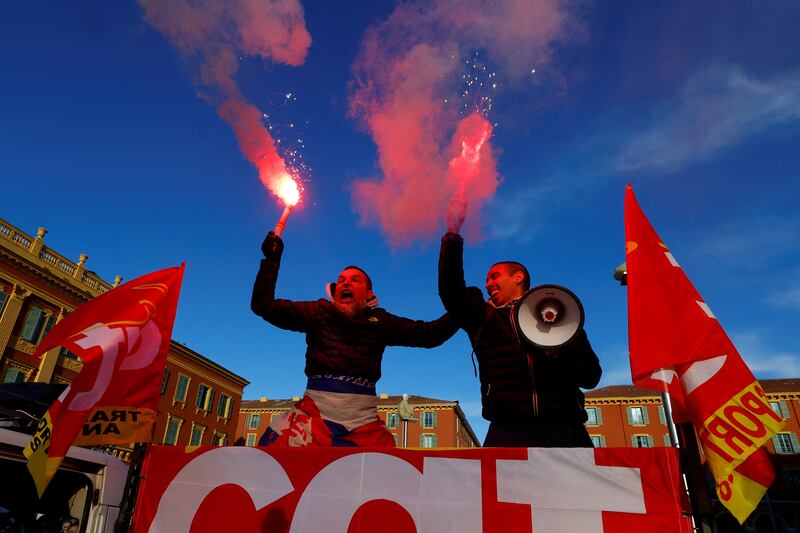 Protesters wield flares and CGT labour union flags during a demonstration against French government's pension reform plan in Nice. Reuters