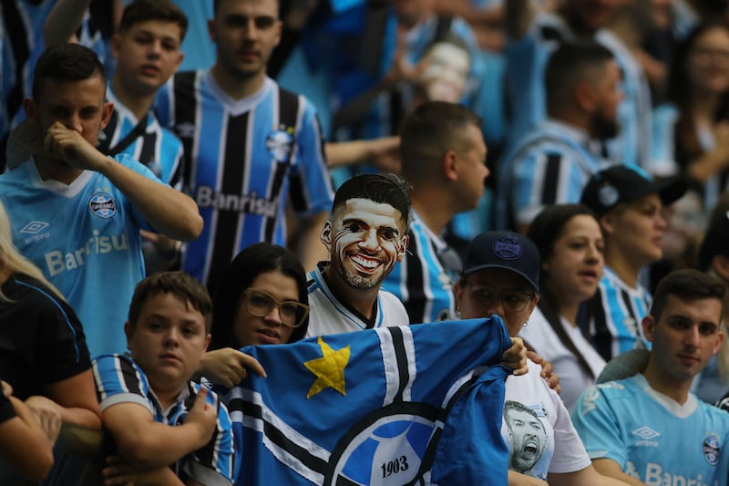 A Gremio fan wearing a Luis Suarez mask before the match. AFP